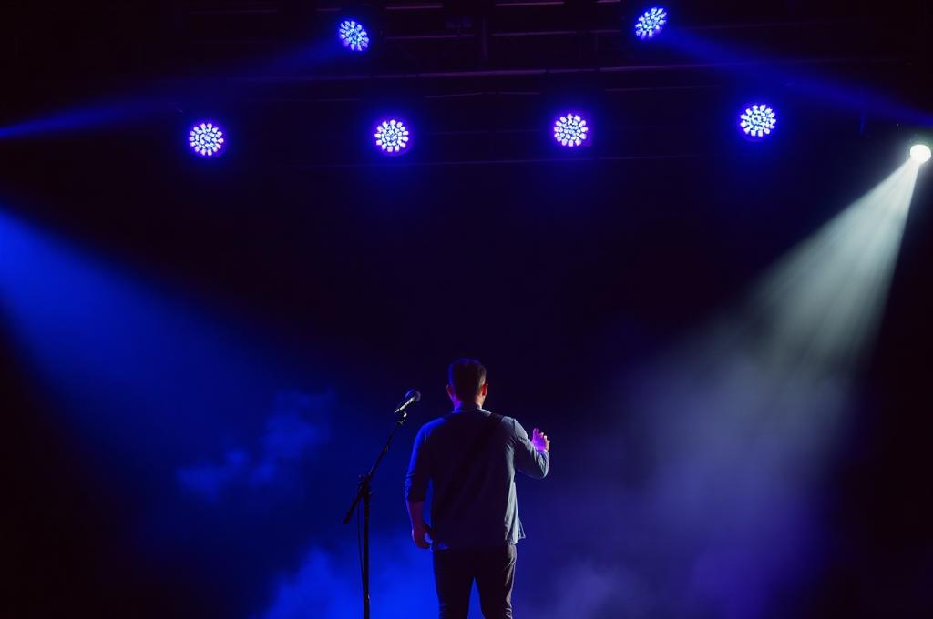 Performer on stage under stage lights